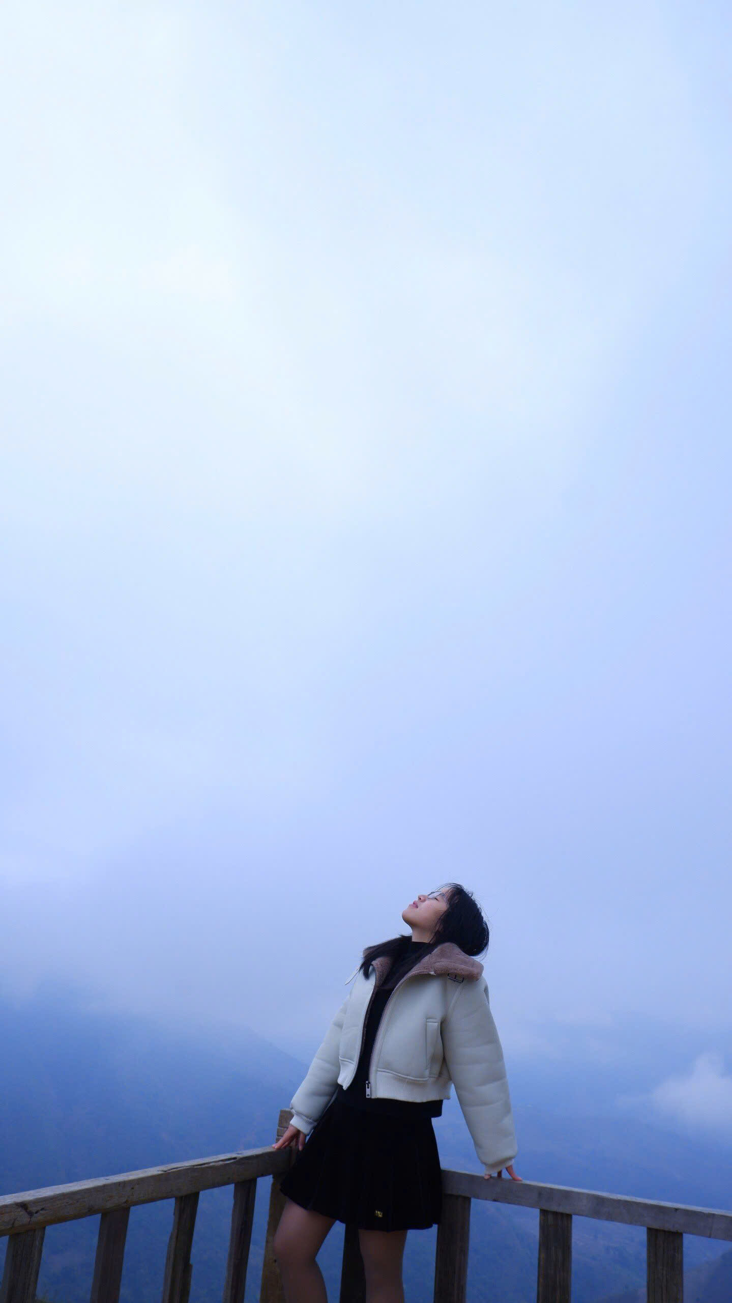 Quỳnh Anh Bùi at 16—after a drive up the mountain to find the sunset—shivering from the cold as the clouds enveloped us. We decided to take a photo before waiting for the light to reach the café. (This photo was taken by a complete stranger.)